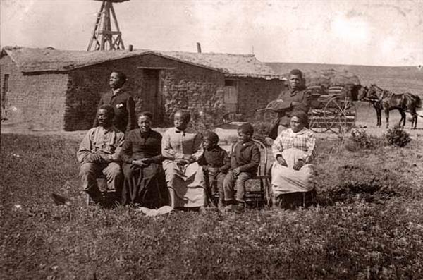 The Speese family poses outside of their homestead
